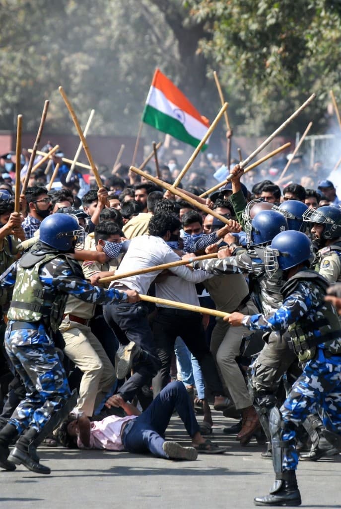 Police and protesters clash with lathis as Indian flag waves